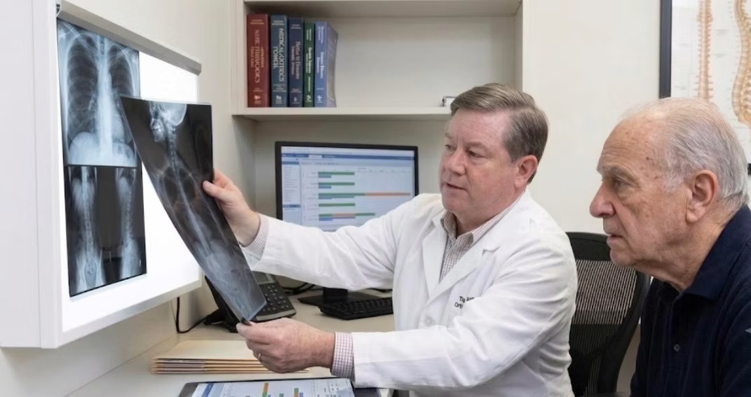 Spine Surgeon showing x-ray